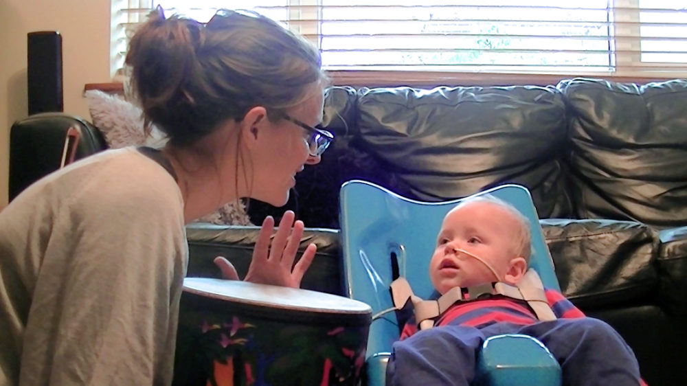 Adult makes eye contact with baby